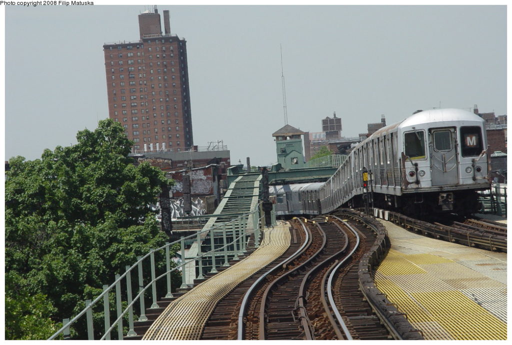 M train passes by the abandoned upper level at Myrtle Ave.  Photo by Filip Matuska via nycsubway.org