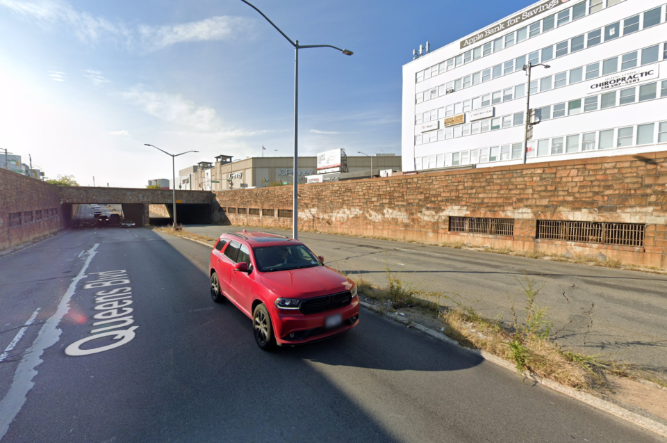 Queens Blvd at Woodhaven Blvd. Grates on the side walls are vents for the subway below. Source Google.